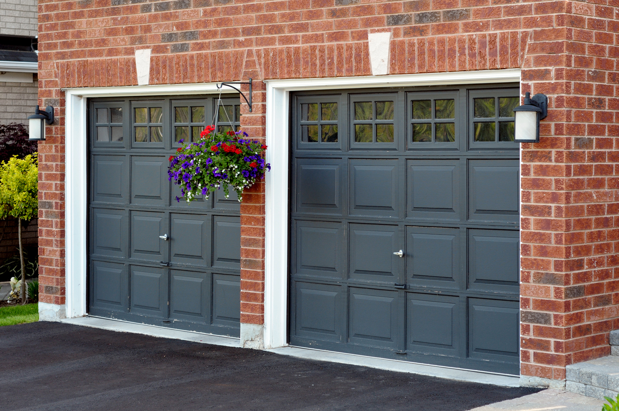 Garage doors with hanging planters and lanterns