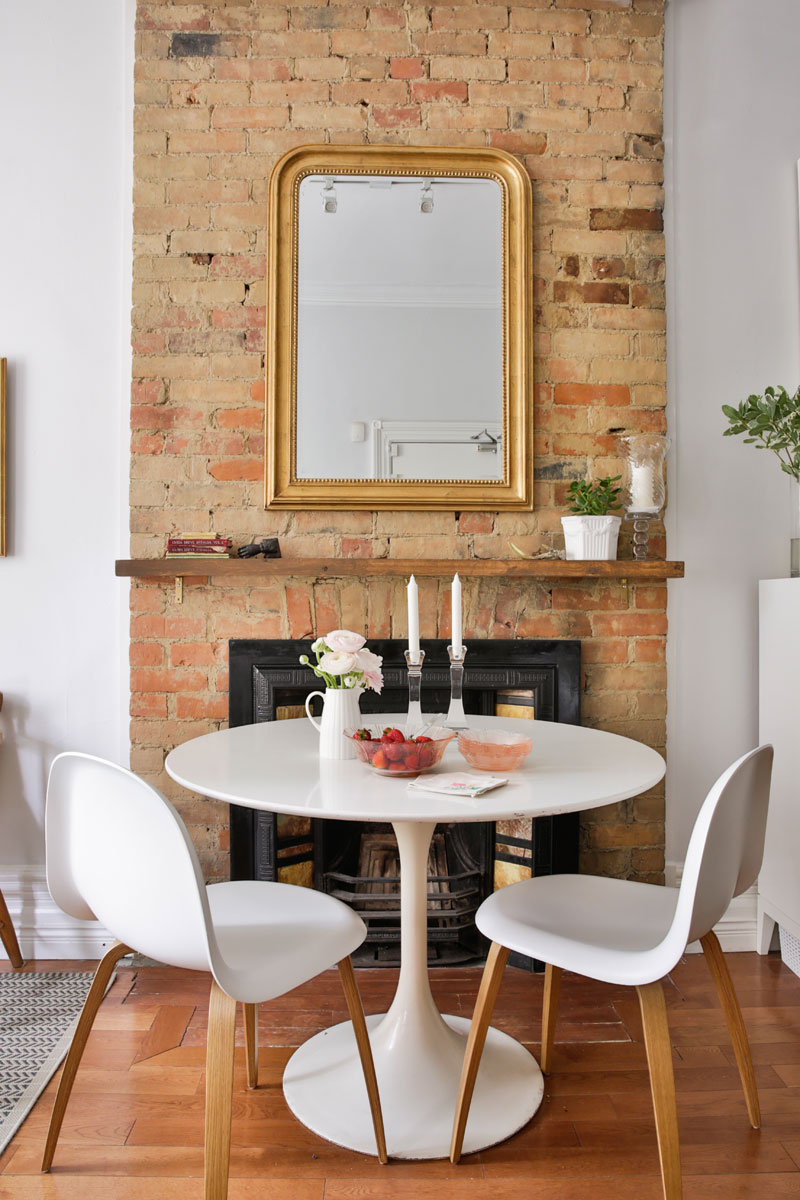 Fireplace with Parisian gold mirror set against the home's original bric