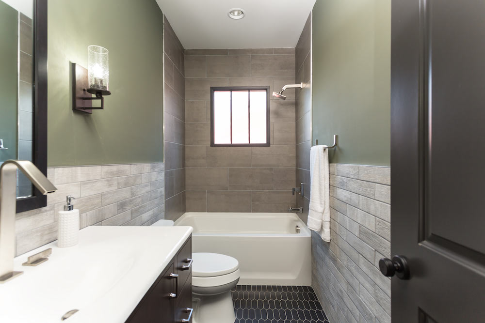 Masters of Flip luxe lodge main floor bathroom with sage-green walls and three different styles of tile