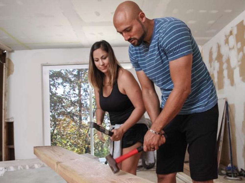 Rustic Rehab hosts Chenoa and David Rivera hammer a piece of wood together
