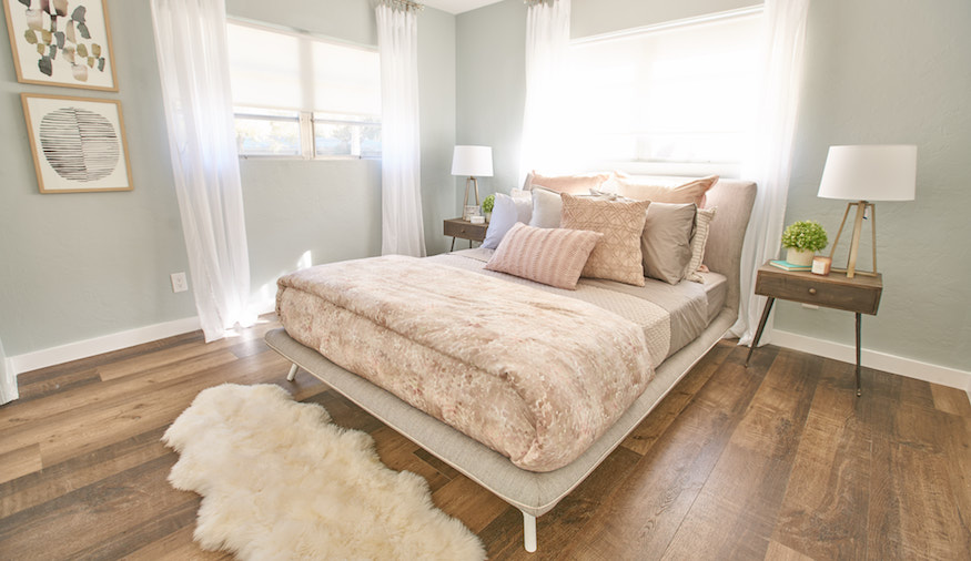 Freshly updated spare bedroom with accents of pink and taupe on buyers bootcamp