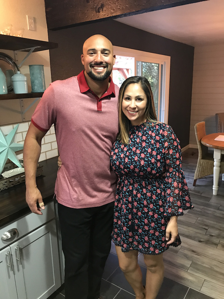 Rustic Rehab hosts Chenoa and David Rivera stand in a renovated kitchen