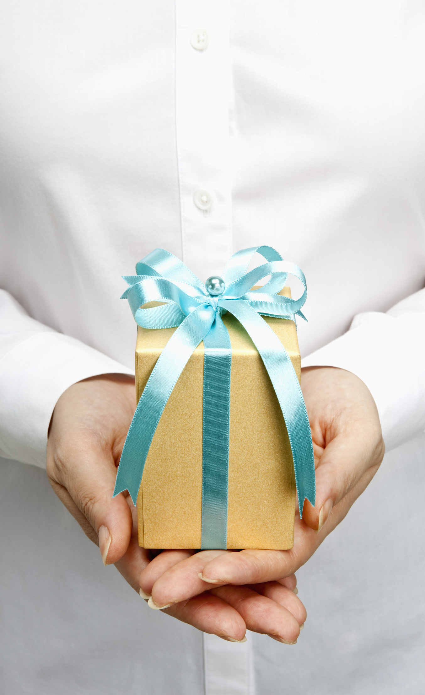 Hands extended with small gift