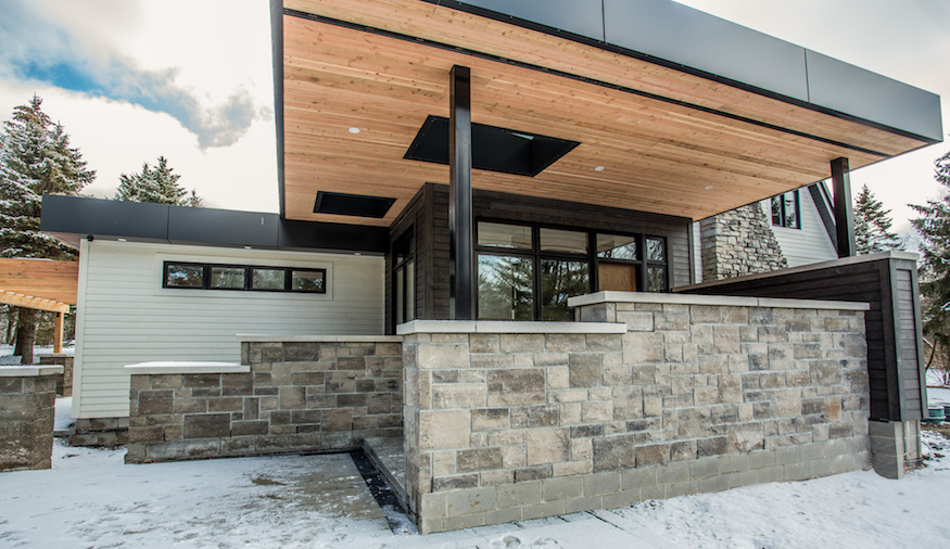 Modern exterior home with stone and stylish siding.