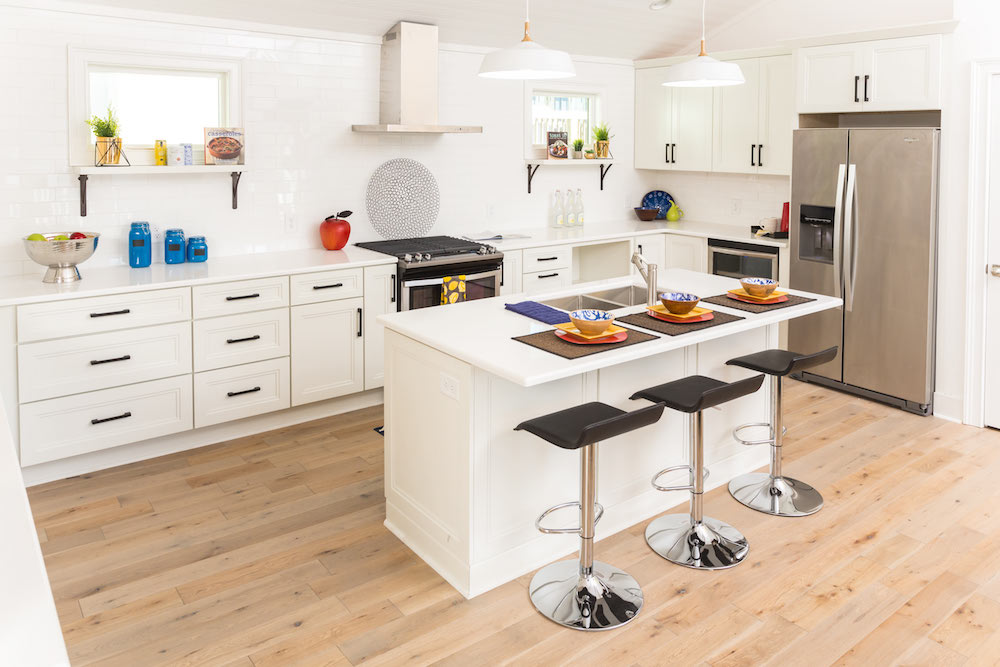 Masters of Flip primary colour renovation white kitchen with island and black bar stools