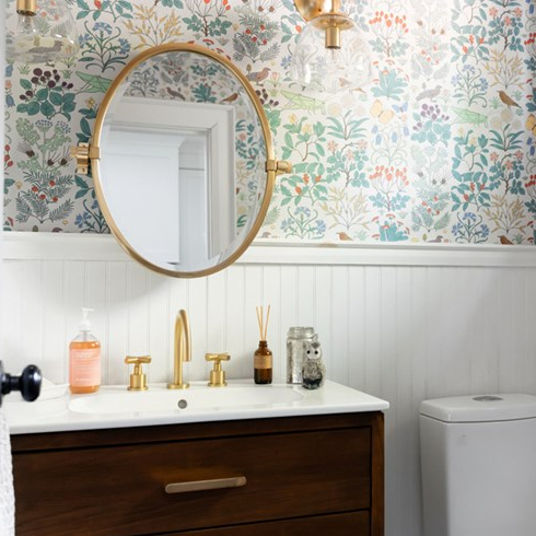 A beautiful powder room with vintage wallpaper