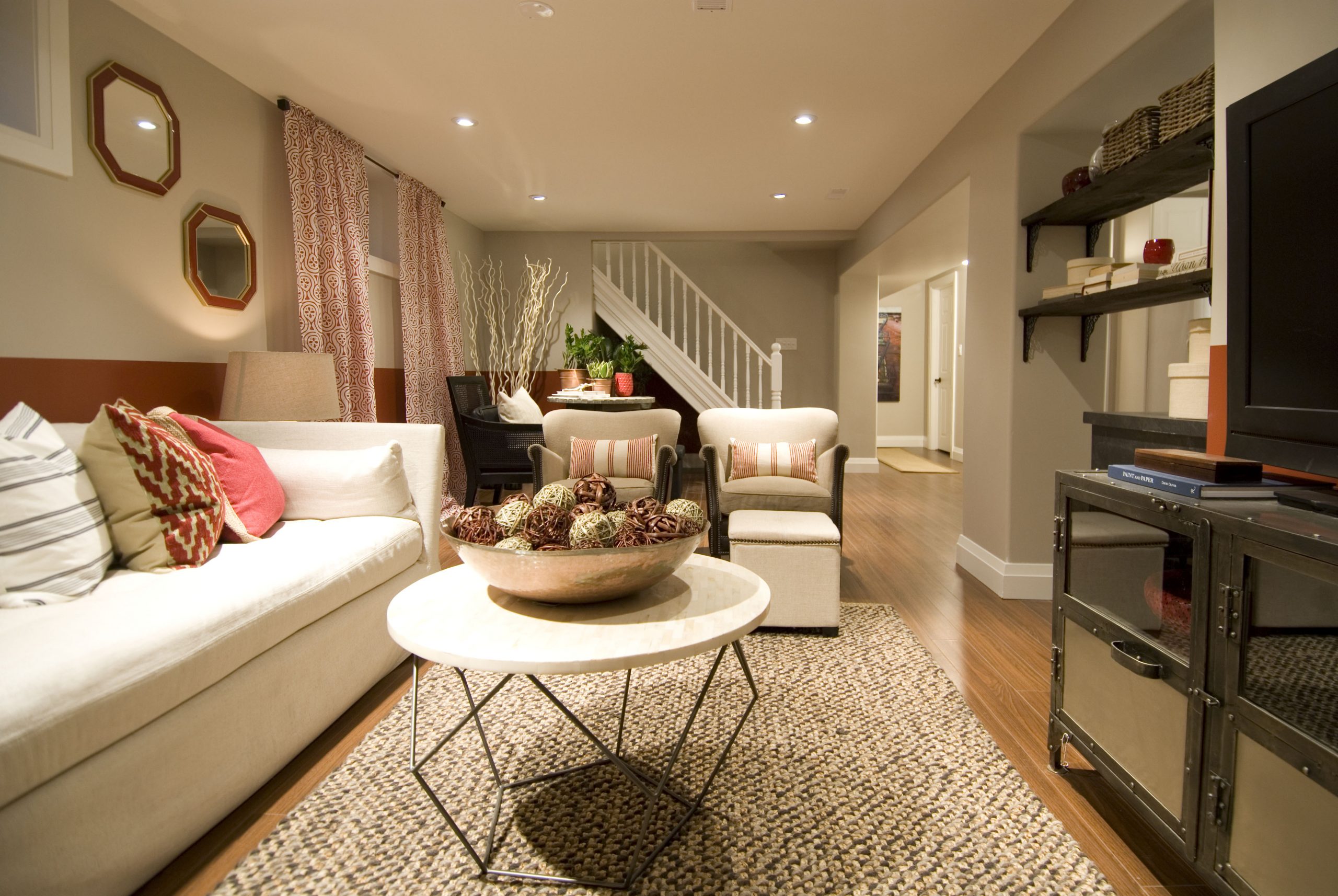 Basement apartment with white sofa and pink accents