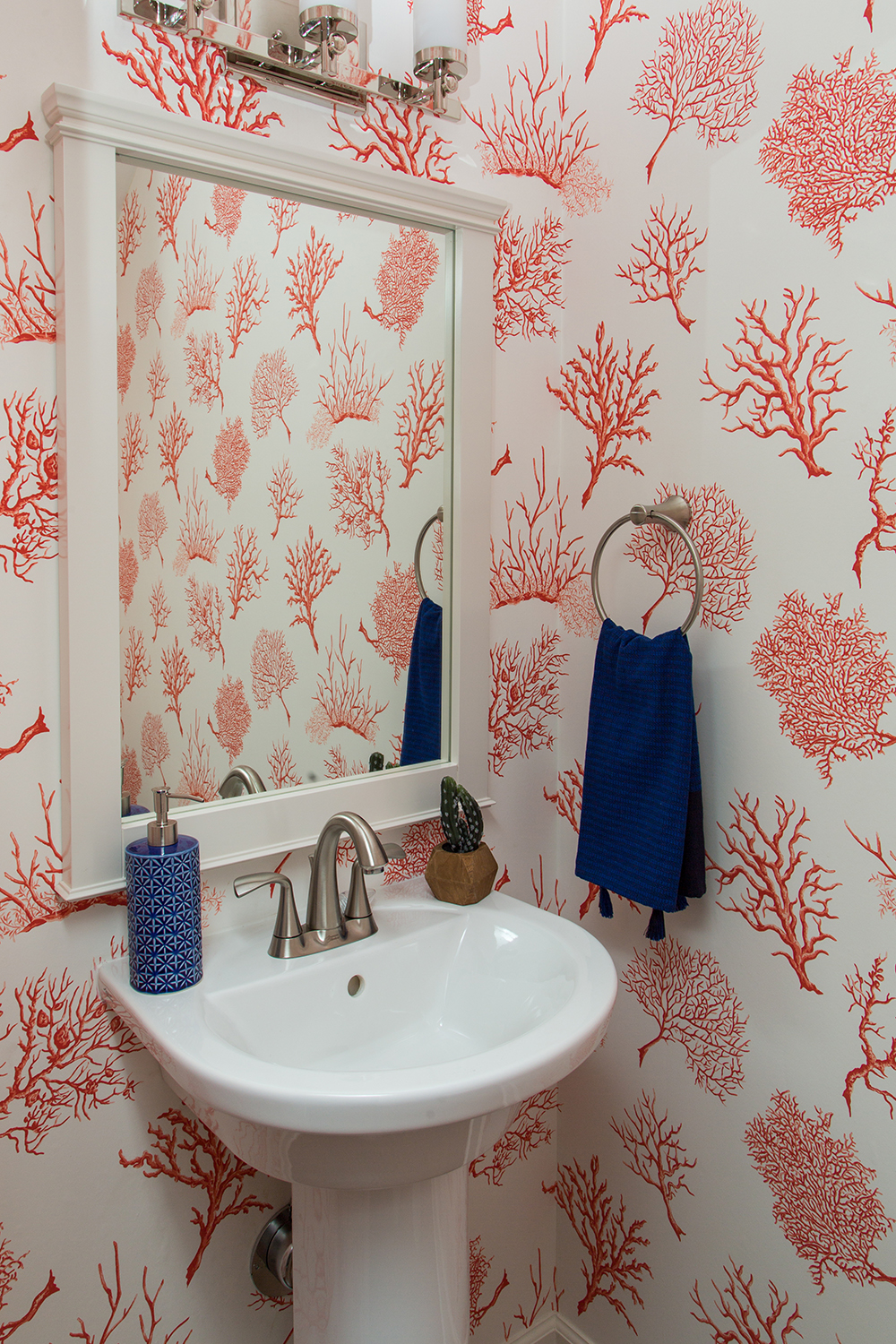 Powder room with coral wallpaper