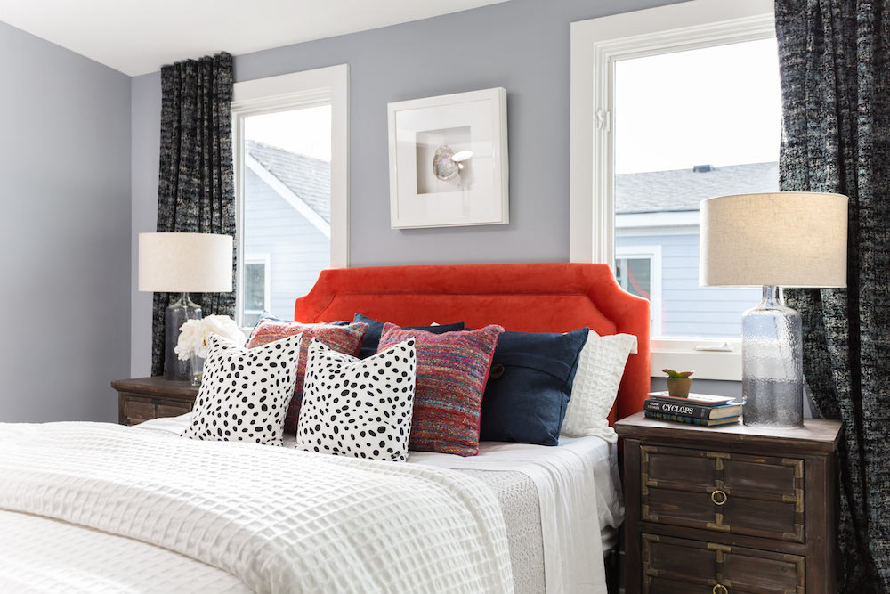Masters of Flip train station house bedroom with red headboard and grey walls