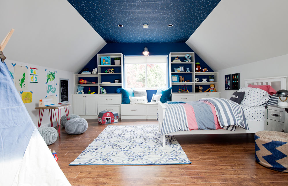 Dashing blue bedroom by Jillian Harris with built-ins and window seat.