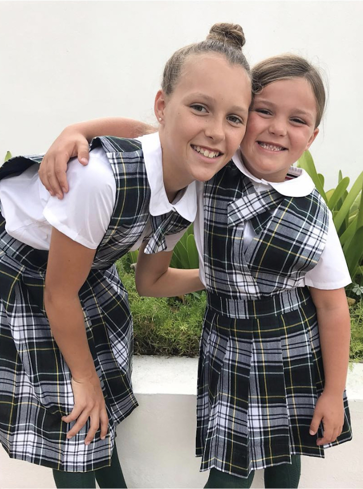 Charlotte and Josephine Baeumler wear plaid school uniforms