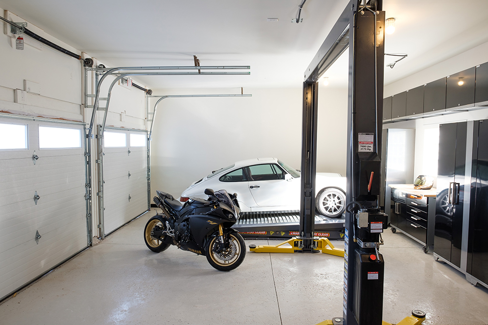 Luxury garage with a motorcycle and a white Porche