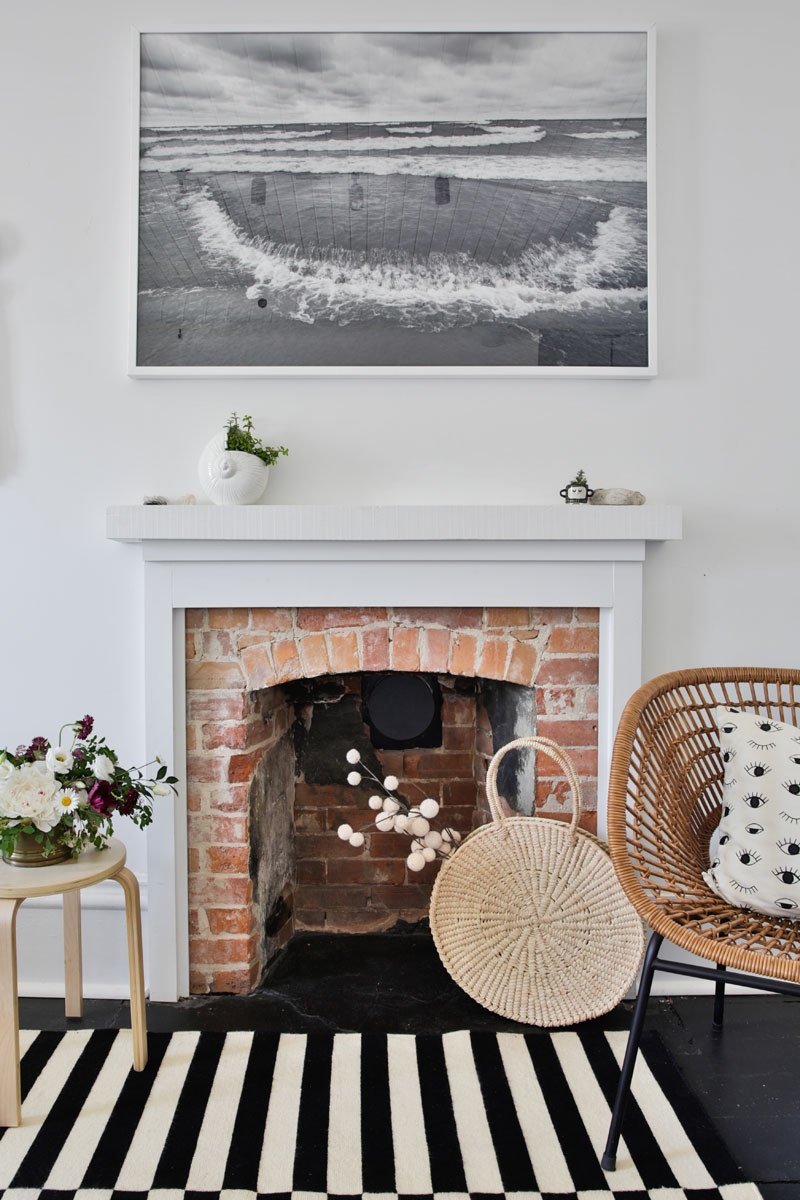 A black-and-white photograph and small quirky pieces bring serenity to this living room.