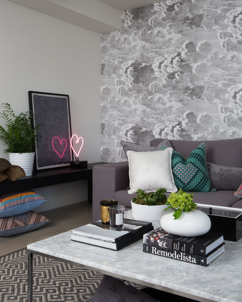 grey-on-grey space is uplifted with dreamy cloud wallpaper and heart-shaped neon lights.