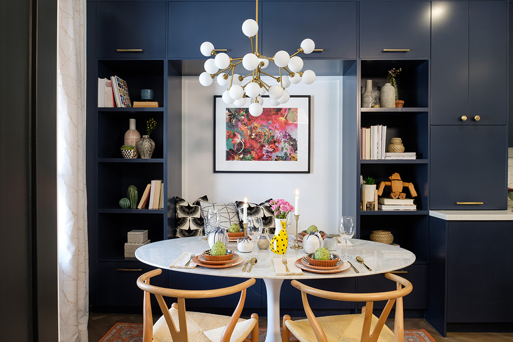Blue modern dining nook with mid century modern chairs and multi globe chandelier