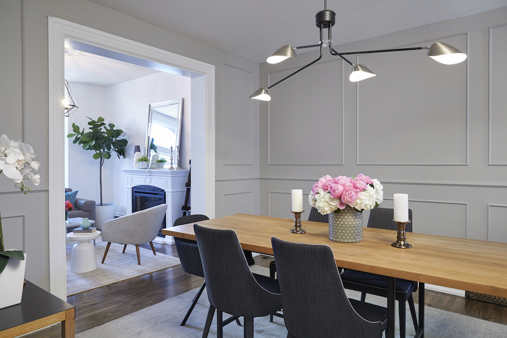 grey dining room with wood table and modern light fixture