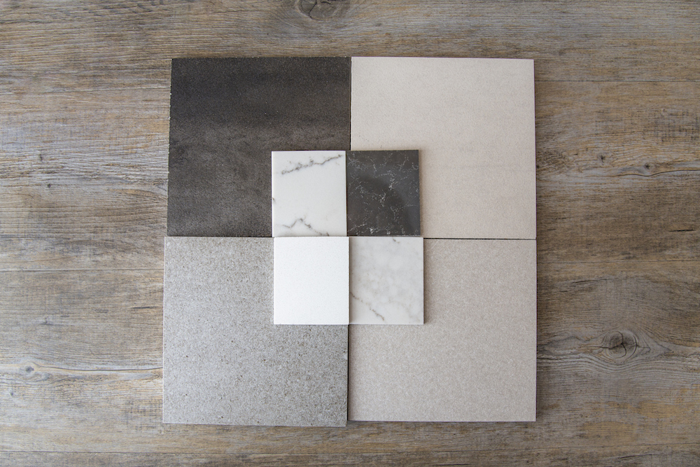 Benchtop and wall tile samples on a wooden floorboard background