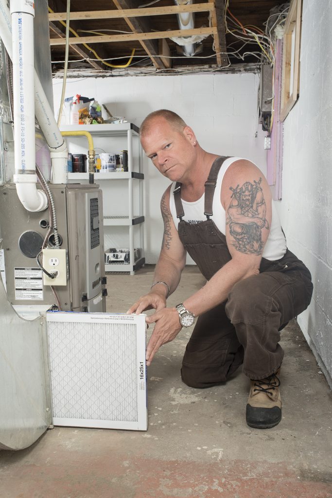 Mike Holmes replacing a home's HVAC filter