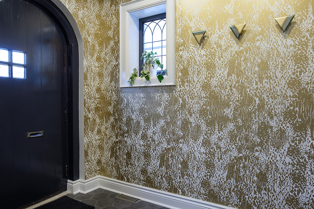 Entryway with gold wallpaper and lean paned window