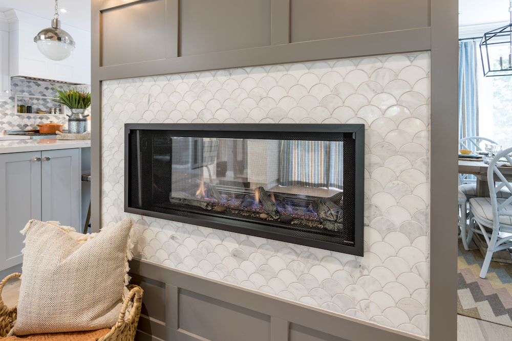 New see-through gas fireplace with white scallop tiles