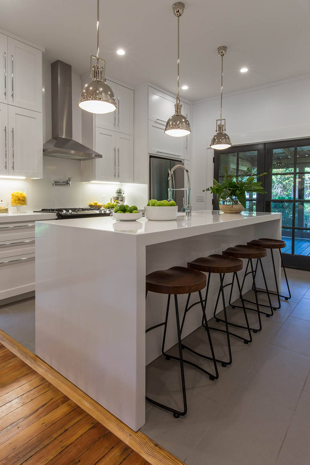 A white quartz countertop in an open concept kitchen.