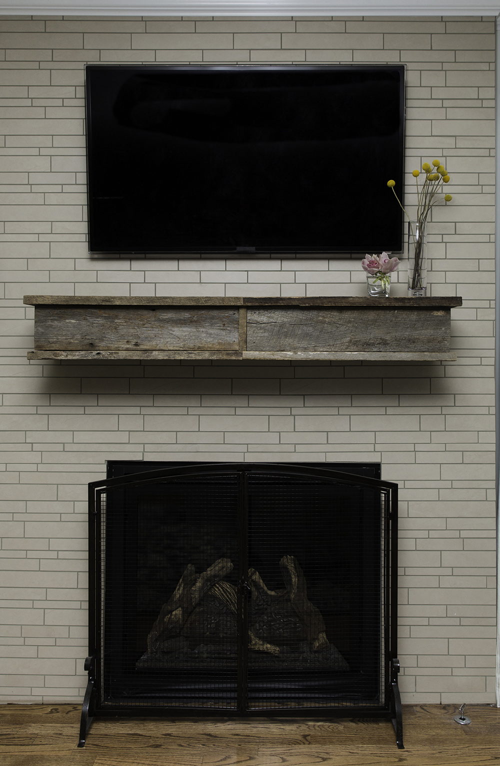 The focal point of the living room is the mantel made from reclaimed barn wood, which Maureen’s husband salvaged after church one day and put aside for a future project.