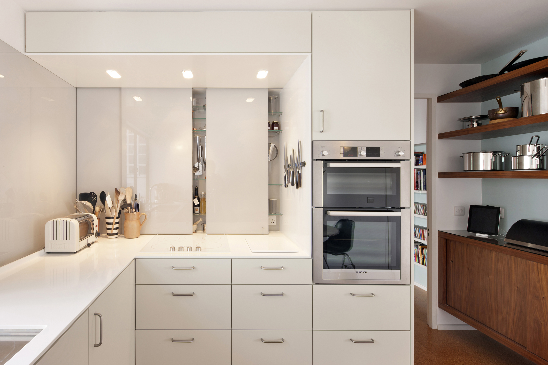 Kitchen with sliding panels hiding appliances