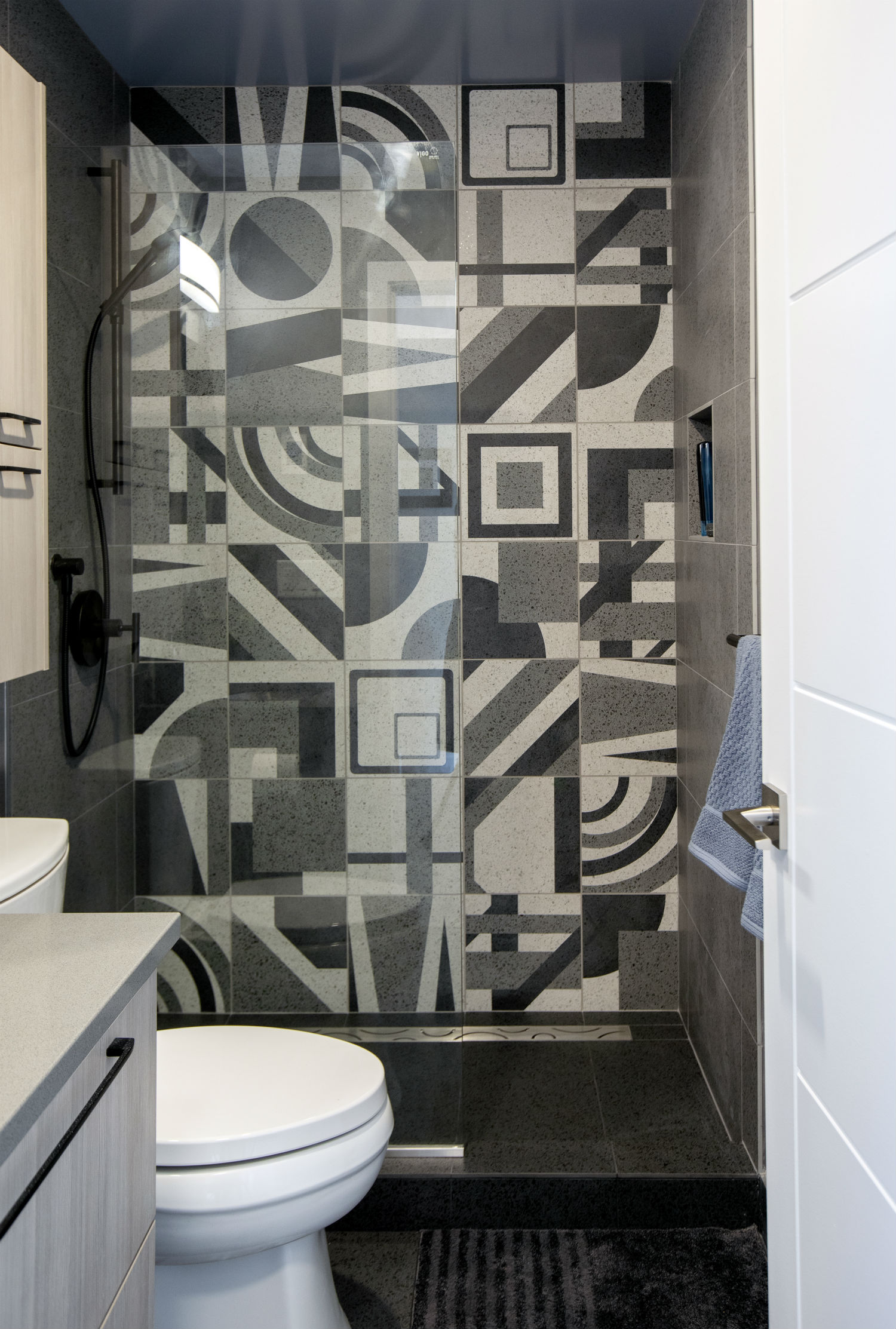 Graphic black, white and grey tile in a large shower
