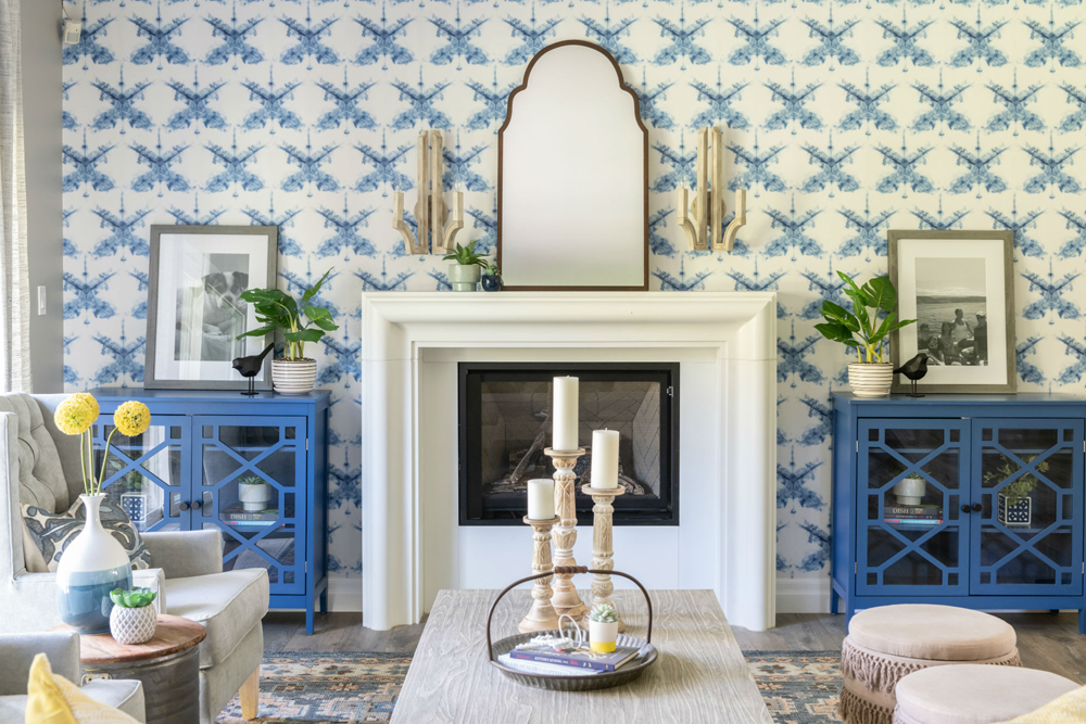 A blue and white coastal themed living room with a gas fireplace