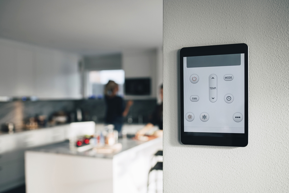 High-tech thermostat mounted on a kitchen wall