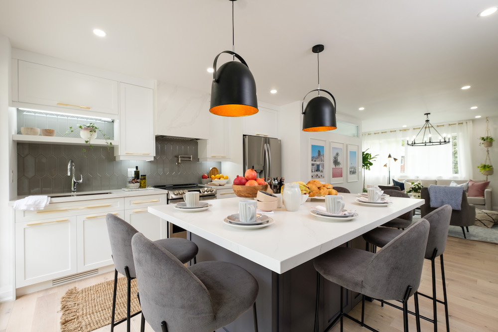 spacious kitchen with glossy grey backsplash tiles and large kitchen island