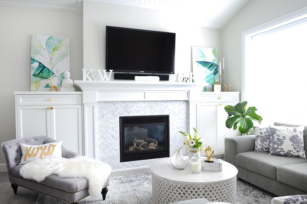 Coastal glam living room with herringbone tile fireplace surround.
