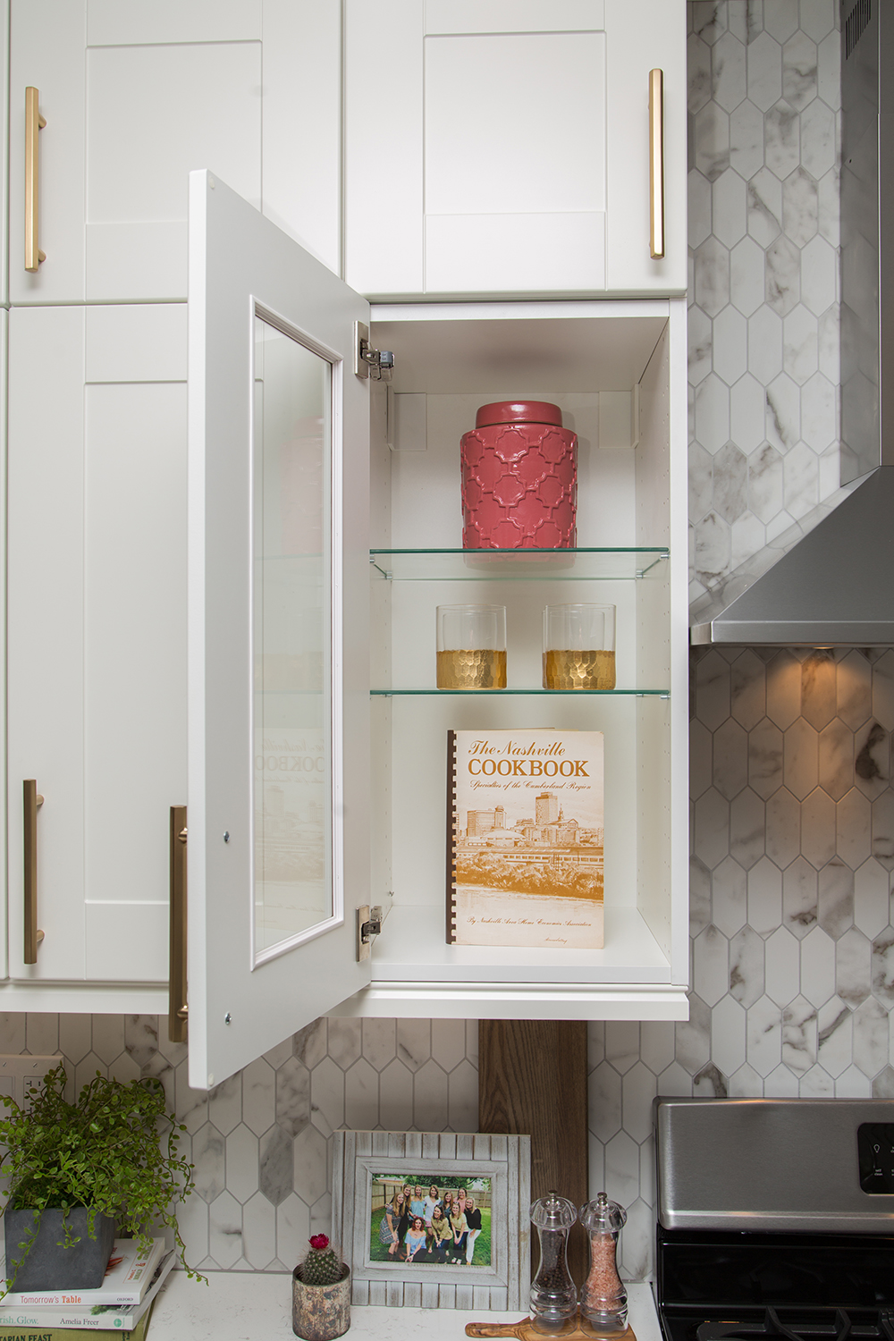 Kitchen cabinet with decor and cookbook on display