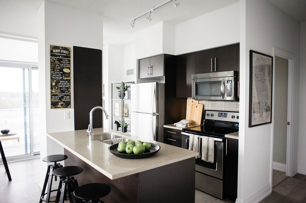 Modern black and white condo kitchen design.