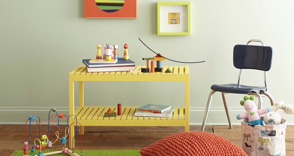 Playroom with wood floors, a yellow play bench, a blue school chair and BEHR Spring Valley S390-2 painted on the walls