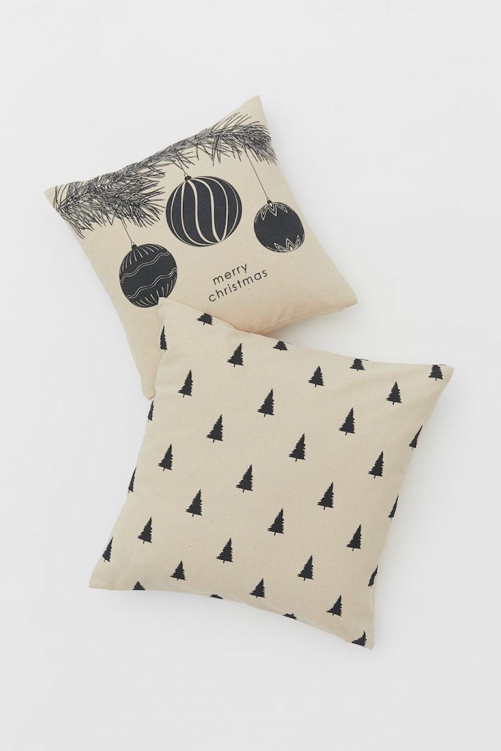 Two coordinated cushion covers from H&M Home in cotton canvas in different sizes, each with a printed Christmas motif and a concealed zipper at one side