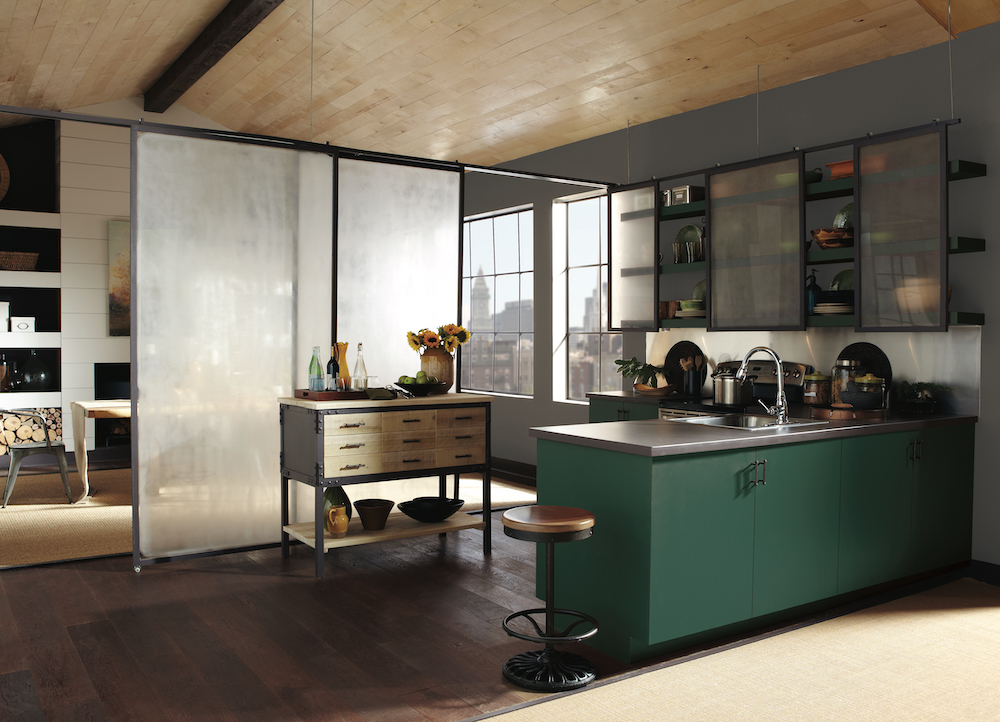 Chic loft kitchen with hardwood floors, metal countertops, and green floating shelves and L-shaped island in BEHR Dark Everglade HDC-CL-21A, sliding shelf frames painted in BEHR Charcoal Blue N490-5, and walls painted in BEHR Mined Coal PPU18-18