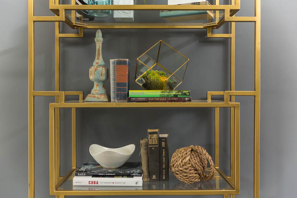 Masters of Flip luxe lodge front hall gold bookcases with funky objects and vintage books