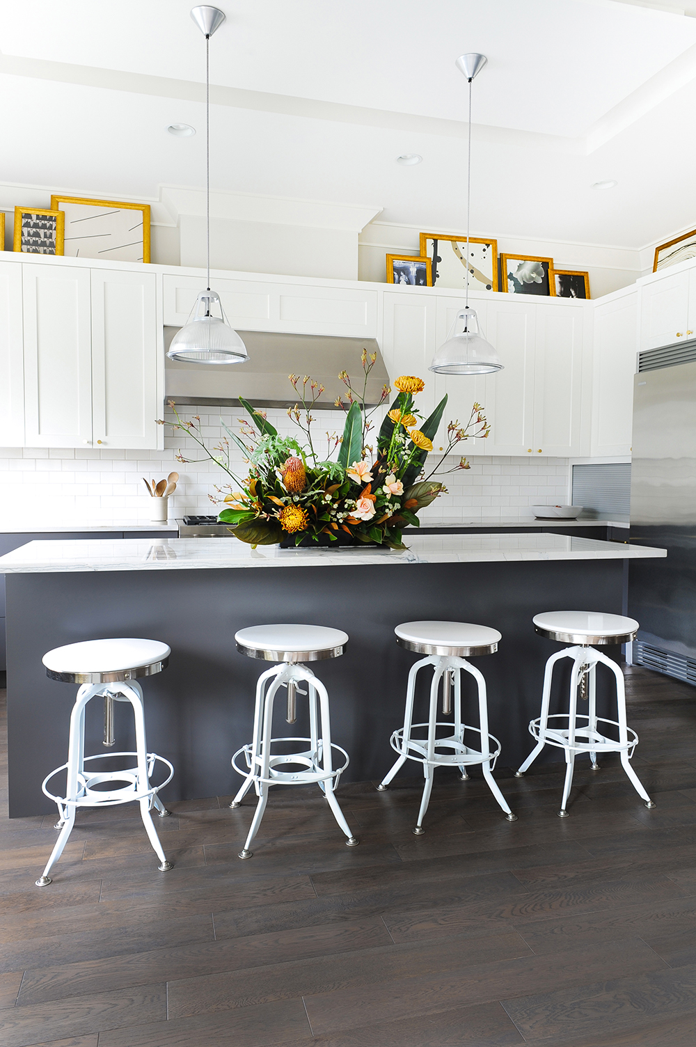 Modern white kitchen with glam artwork.