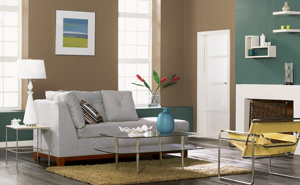Contemporary living with from grey wood floors, a grey chaise lounge, sand coloured shag rug, glass coffee table, modern yellow leather armchair, and walls painted with BEHR Native Soil PPU7-24, Polar Bear 75 and Pine Mountain N420-6