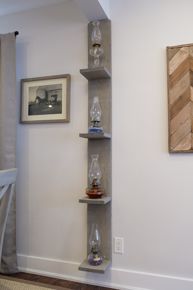 Oil lamp collection is displayed on a custom made grey tower shelf