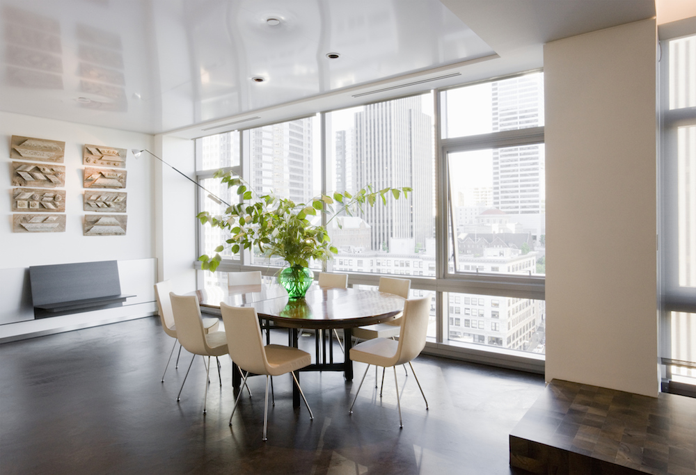 Dining room in luxury high-rise apartment with large windows