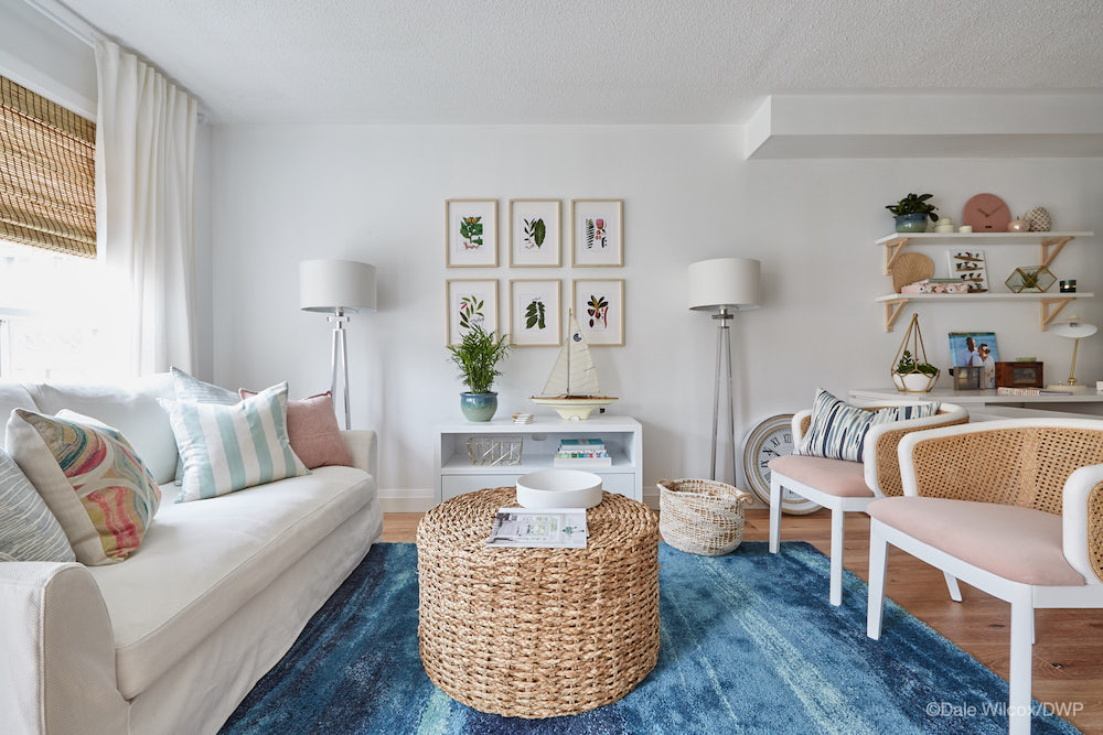 white living room with a blue rug and wicker accents