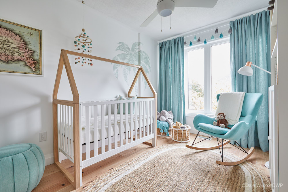 white and blue nursery with white crib and blue rocking chair