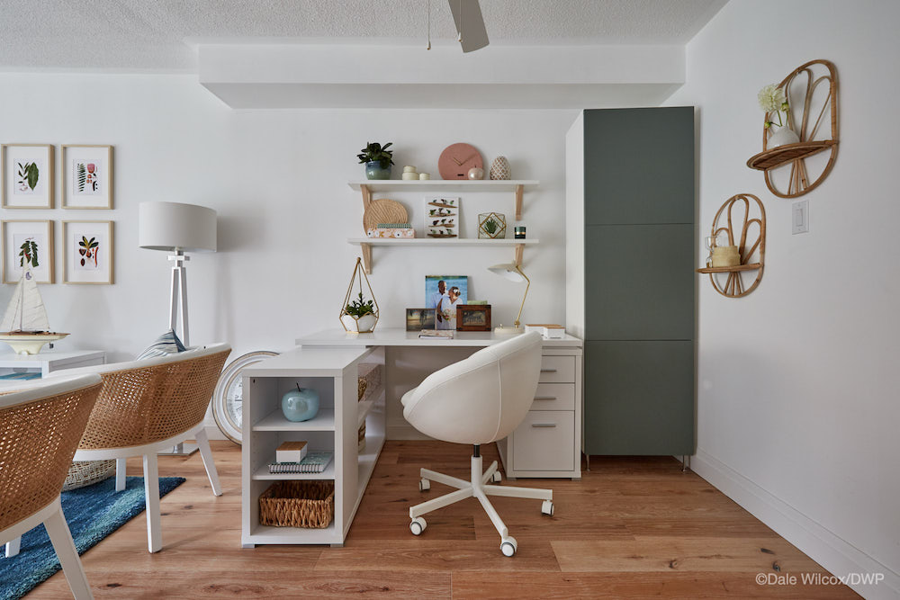 office space in open-concept room with white desk and green cabinet