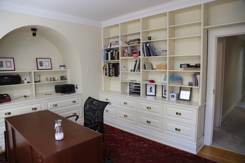 white office with built-in wall shelving