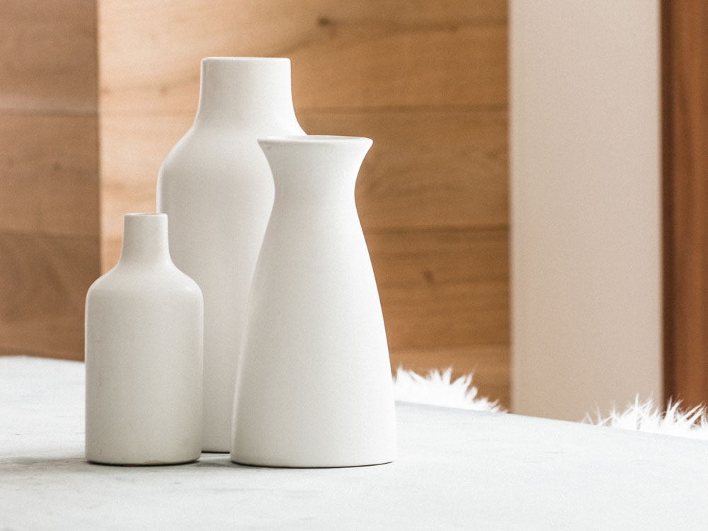Trio of White Vases on coffee table.
