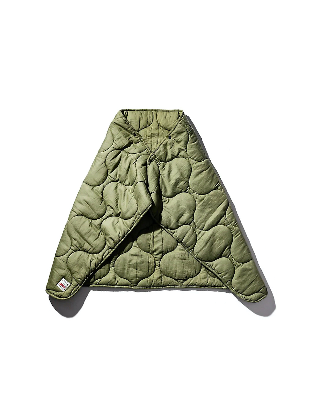 Either worn as a cape or used as a throw, the quilted wrap blanket from Puebco is a militant take on comfort with button clasps to secure everything in place and uses a poly fill for added warmth
