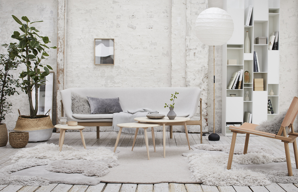 Modern loft apartment with white brick wall, Scandinavian furnishings and sheepskin rugs