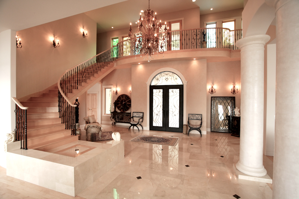 Luxury home interior with marble staircase, floors and columns